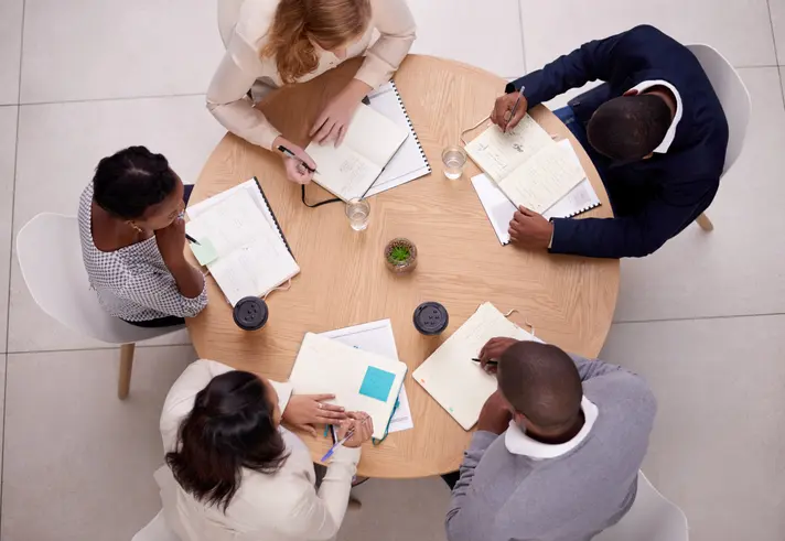 High angle shot of a group of young businesspeople having a meeting in a modern office