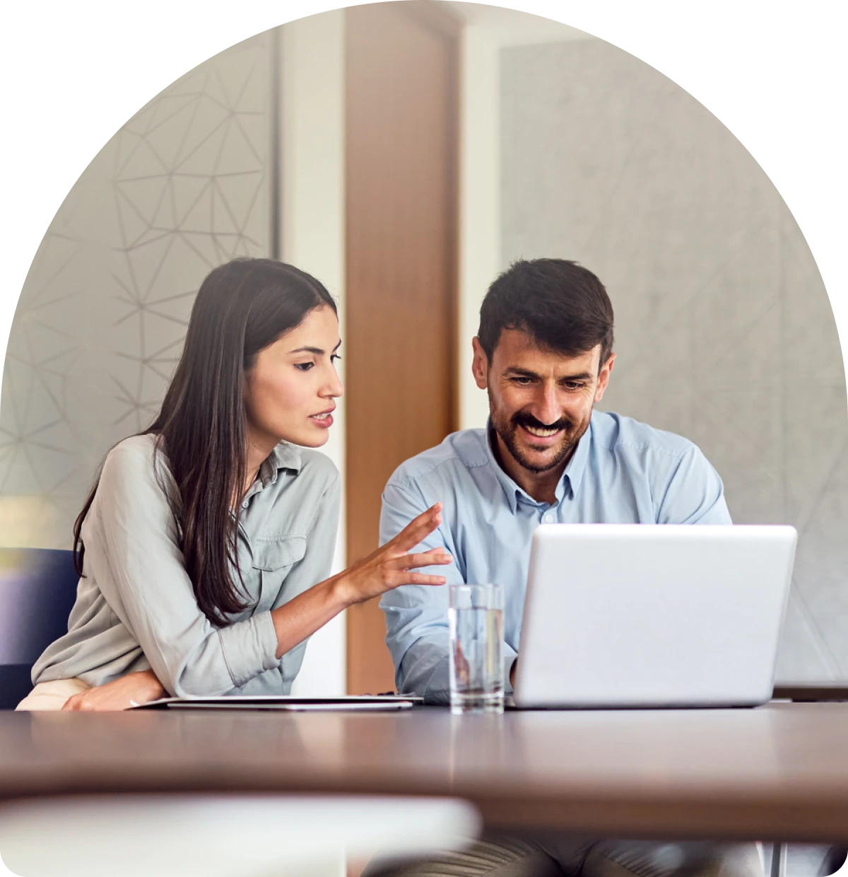 Two people collaborating on a laptop.