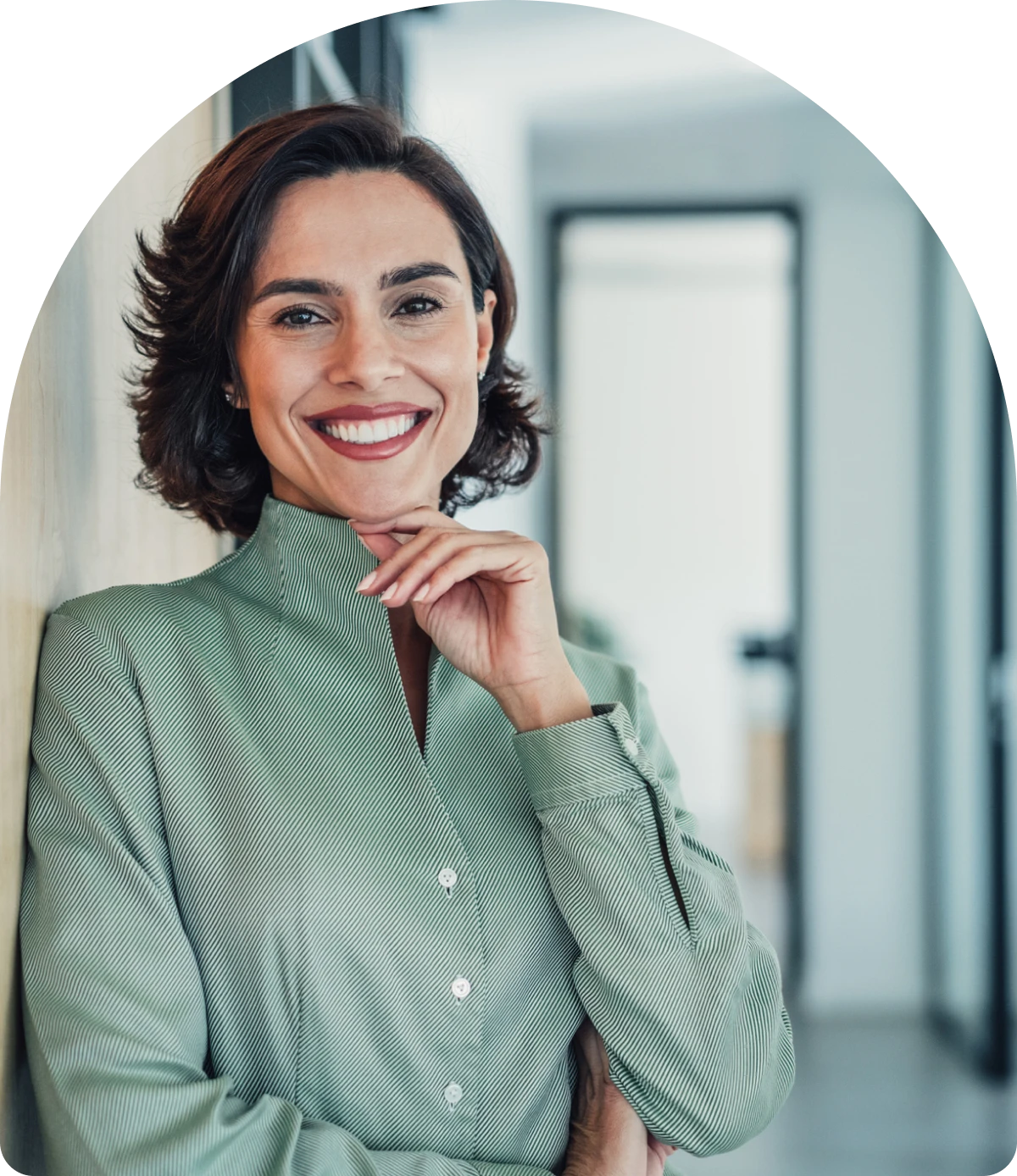 Smiling woman leaning against a wall.